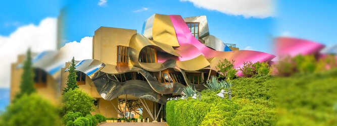 Trip Anti Stress Reisetipps - Marqués de Riscal Design Hotel, Bilbao, Elciego, Spanien. Fantastisch galaktisch, unverkennbar ein Werk von Frank O. Gehry. Inmitten idyllischer Weinberge in der Rioja Region des Baskenlandes, bezaubert das schimmernde Bauobjekt mit einer Struktur bunter, edel glänzender verflochtener Metallbänder. Glanz im Baskenland - Es muss etwas ganz Besonderes sein. Emotional, zukunftsweisend, einzigartig. Denn in dieser Region, etwa 133 km südlich von Bilbao, sind Weingüter normalerweise nicht für die Öffentlichkeit zugänglich.